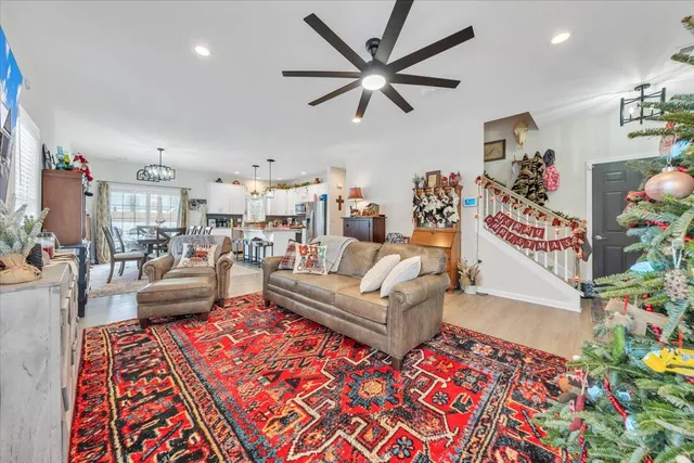a living room with furniture and a painting on the wall