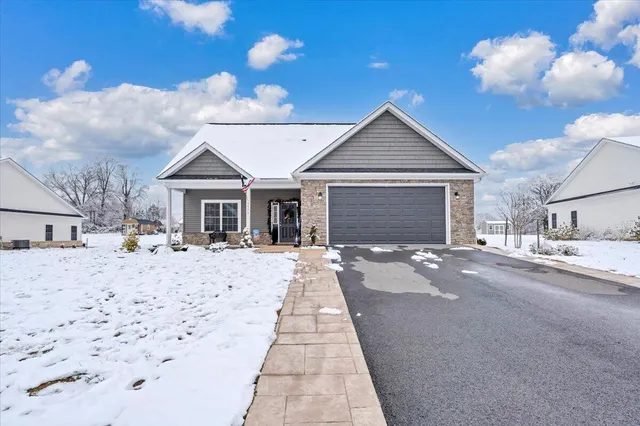 a front view of a house with a yard and chandelier