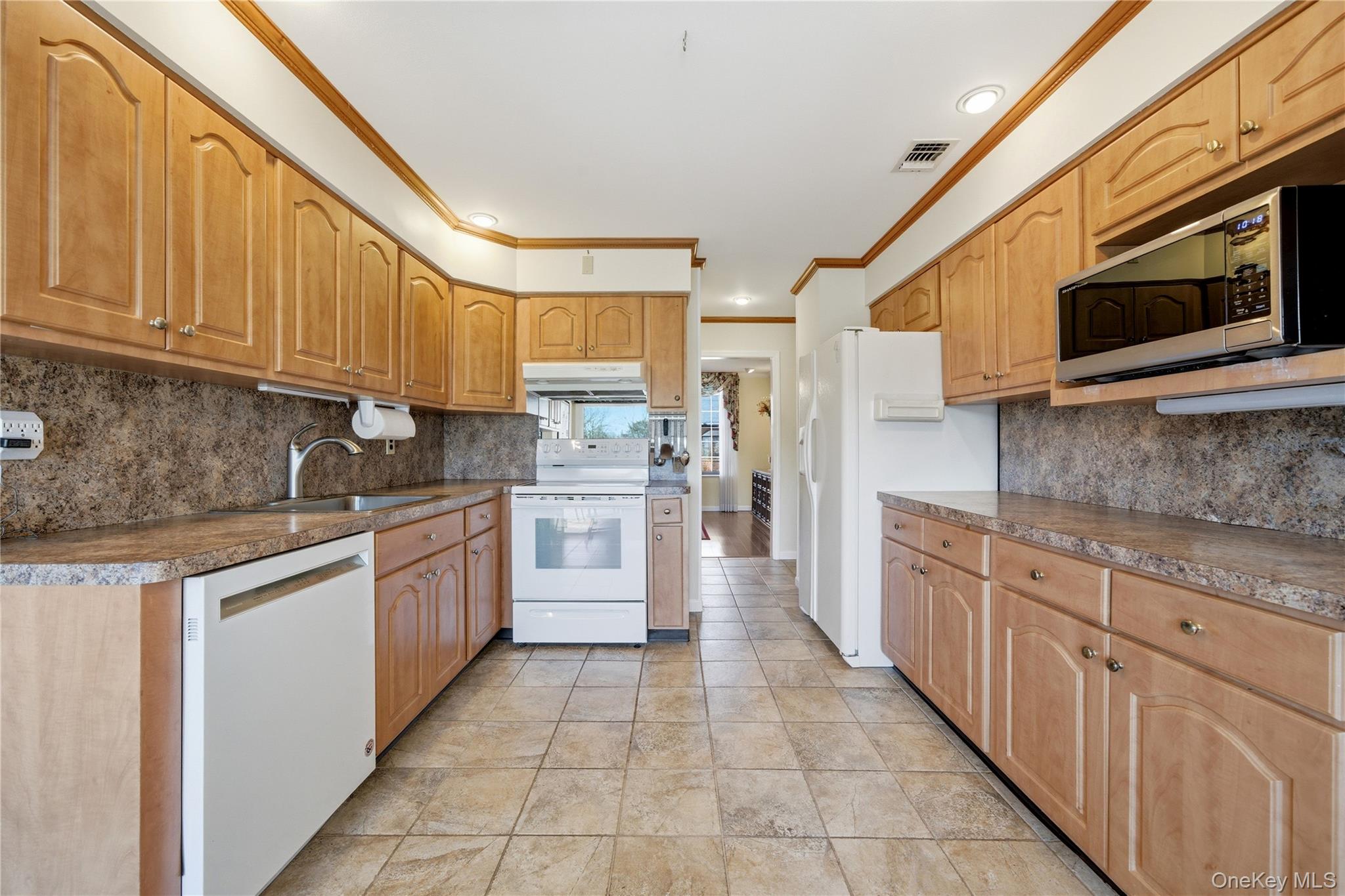 282 Helm Lane Bay Shore, NY 11706 - Photo 12 of 48 a kitchen with stainless steel appliances granite countertop a stove a sink and a microwave