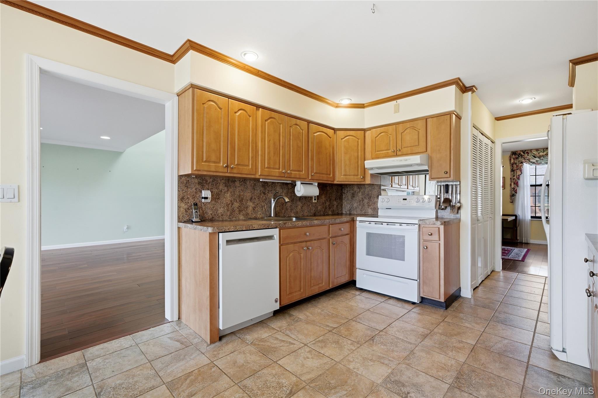 282 Helm Lane Bay Shore, NY 11706 - Photo 13 of 48 a kitchen with white cabinets and white appliances