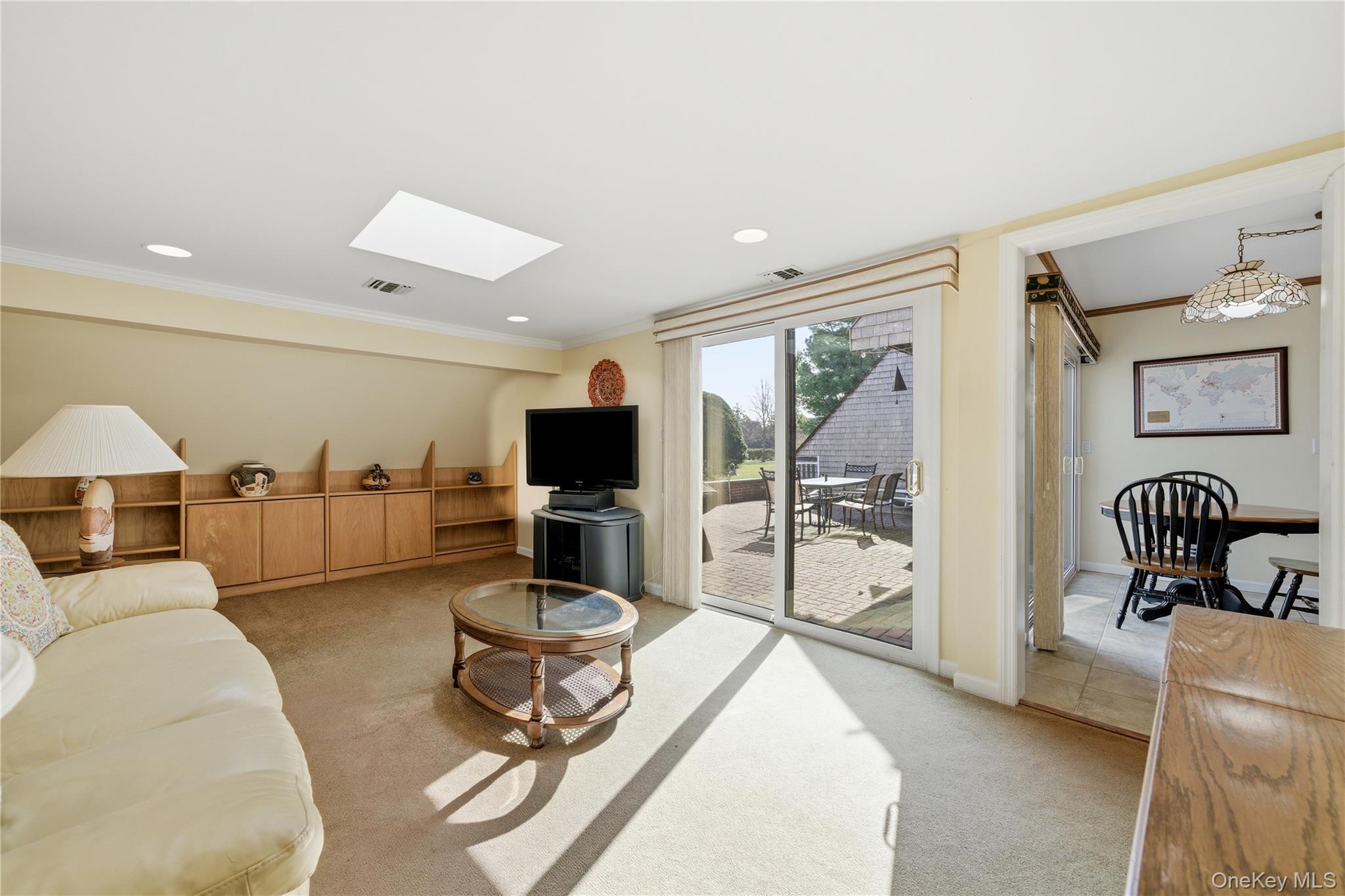 282 Helm Lane Bay Shore, NY 11706 - Photo 16 of 48 a living room with furniture a flat screen tv and a large window
