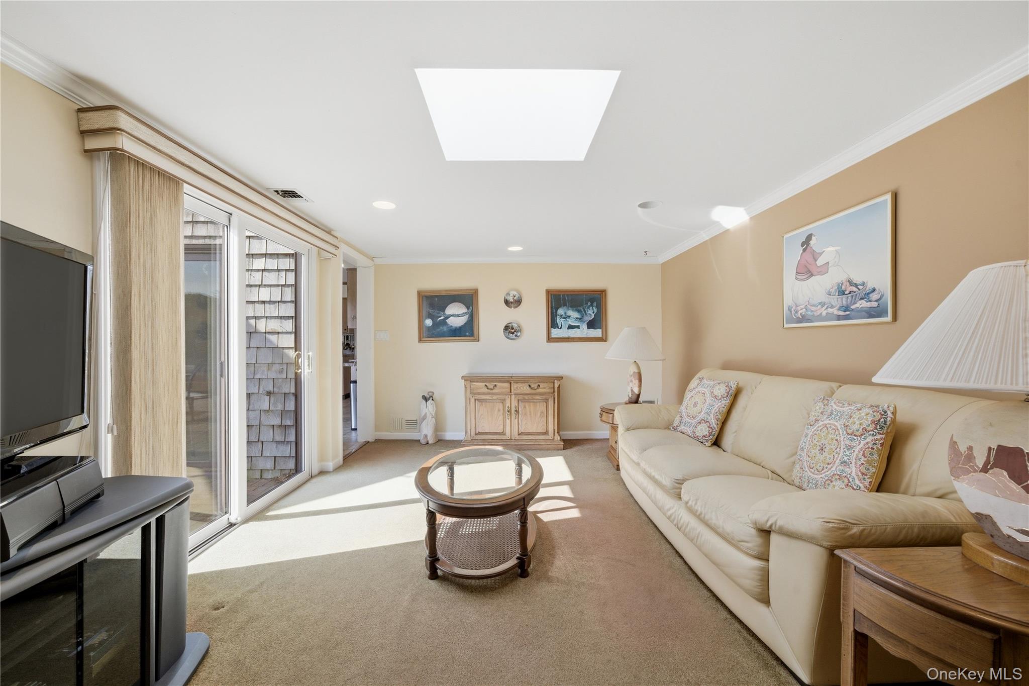 282 Helm Lane Bay Shore, NY 11706 - Photo 17 of 48 a living room with furniture a flat screen tv and a large window