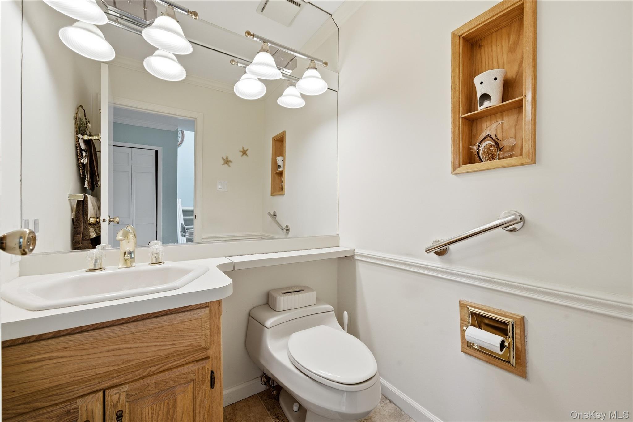 282 Helm Lane Bay Shore, NY 11706 - Photo 20 of 48 a bathroom with a toilet a sink and mirror
