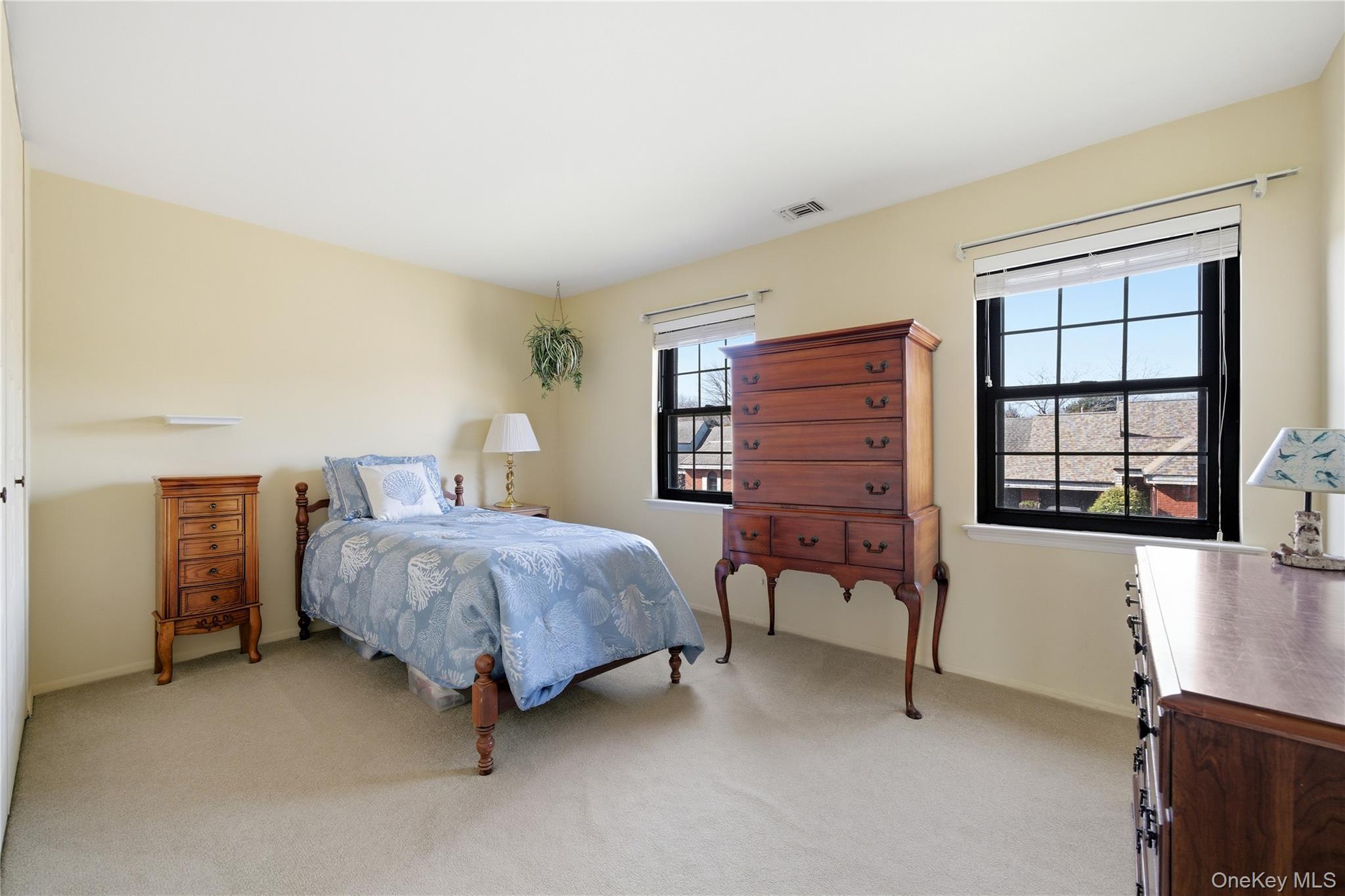 282 Helm Lane Bay Shore, NY 11706 - Photo 26 of 48 a bedroom with a bed dresser and a window