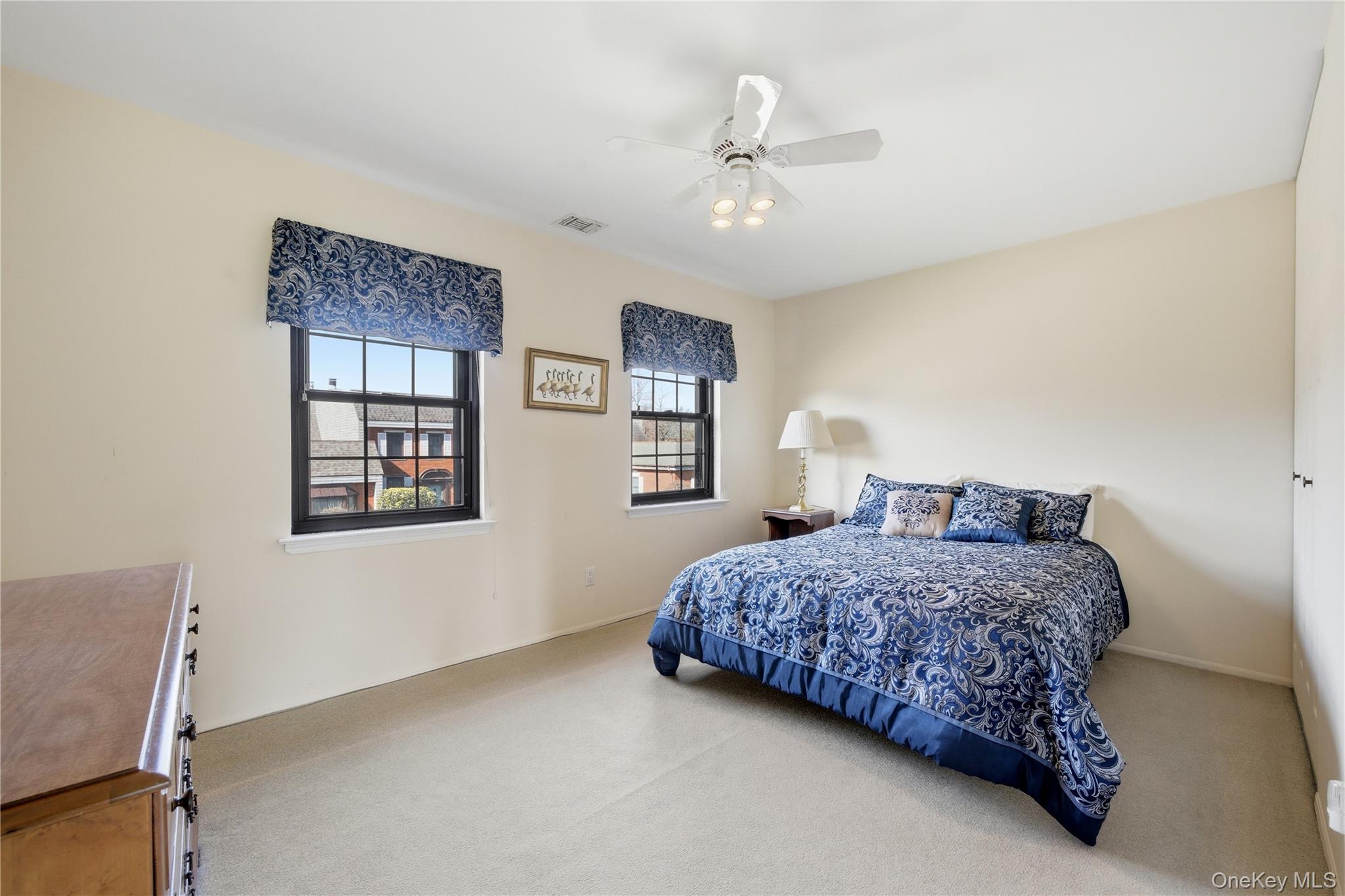 282 Helm Lane Bay Shore, NY 11706 - Photo 27 of 48 a bedroom with a bed chandelier and a window