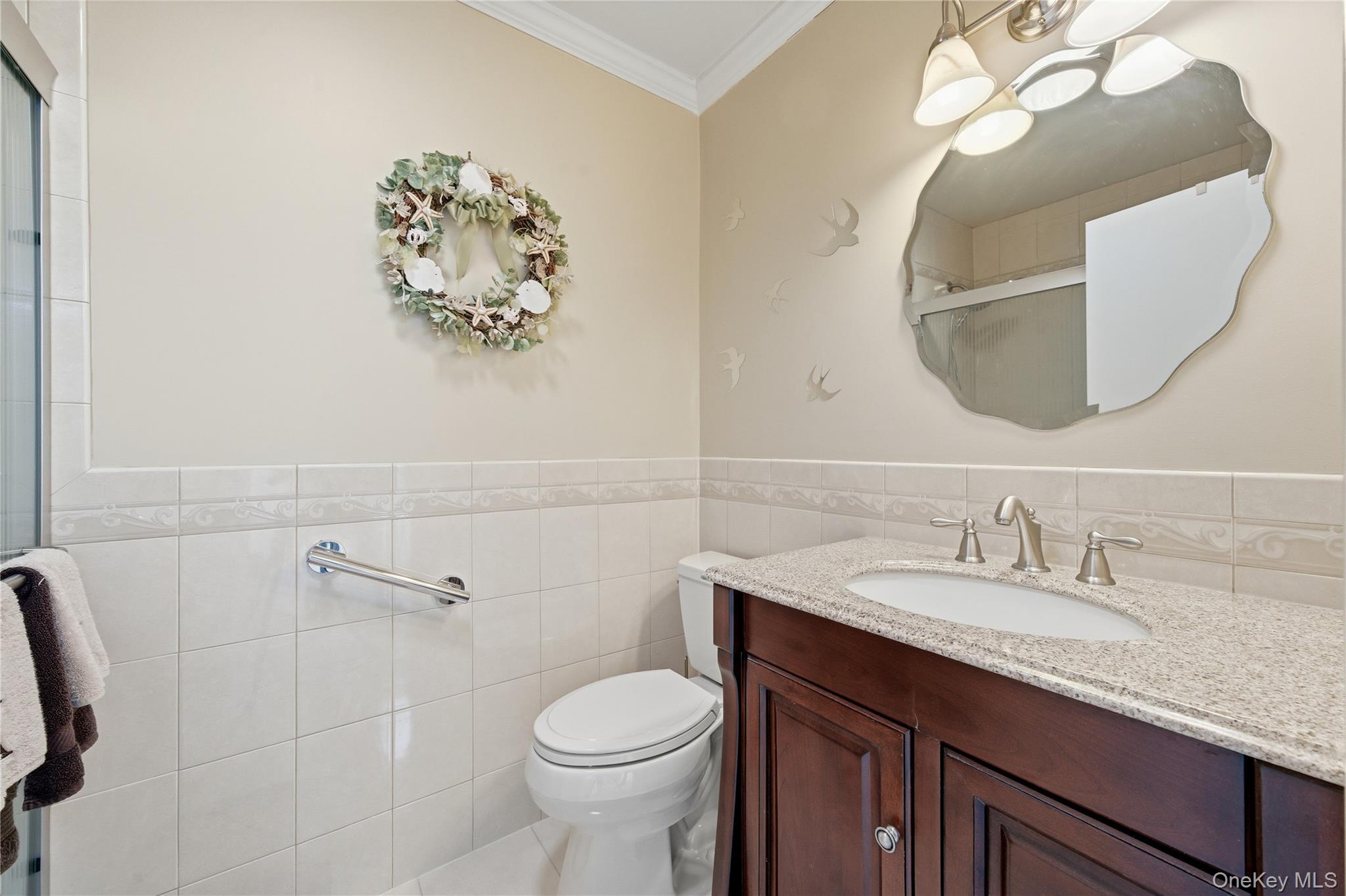 282 Helm Lane Bay Shore, NY 11706 - Photo 28 of 48 a bathroom with a sink and a mirror
