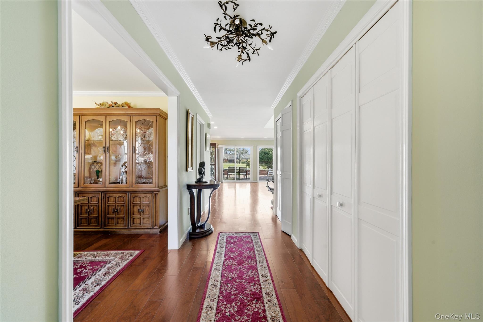 282 Helm Lane Bay Shore, NY 11706 - Photo 3 of 48 a view of a hallway with wooden floor and a living room