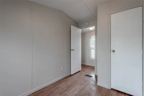 a view of an empty room and wooden floor