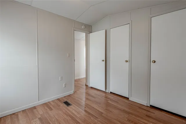 a view of an empty room and wooden floor