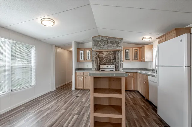 a kitchen with a refrigerator and window