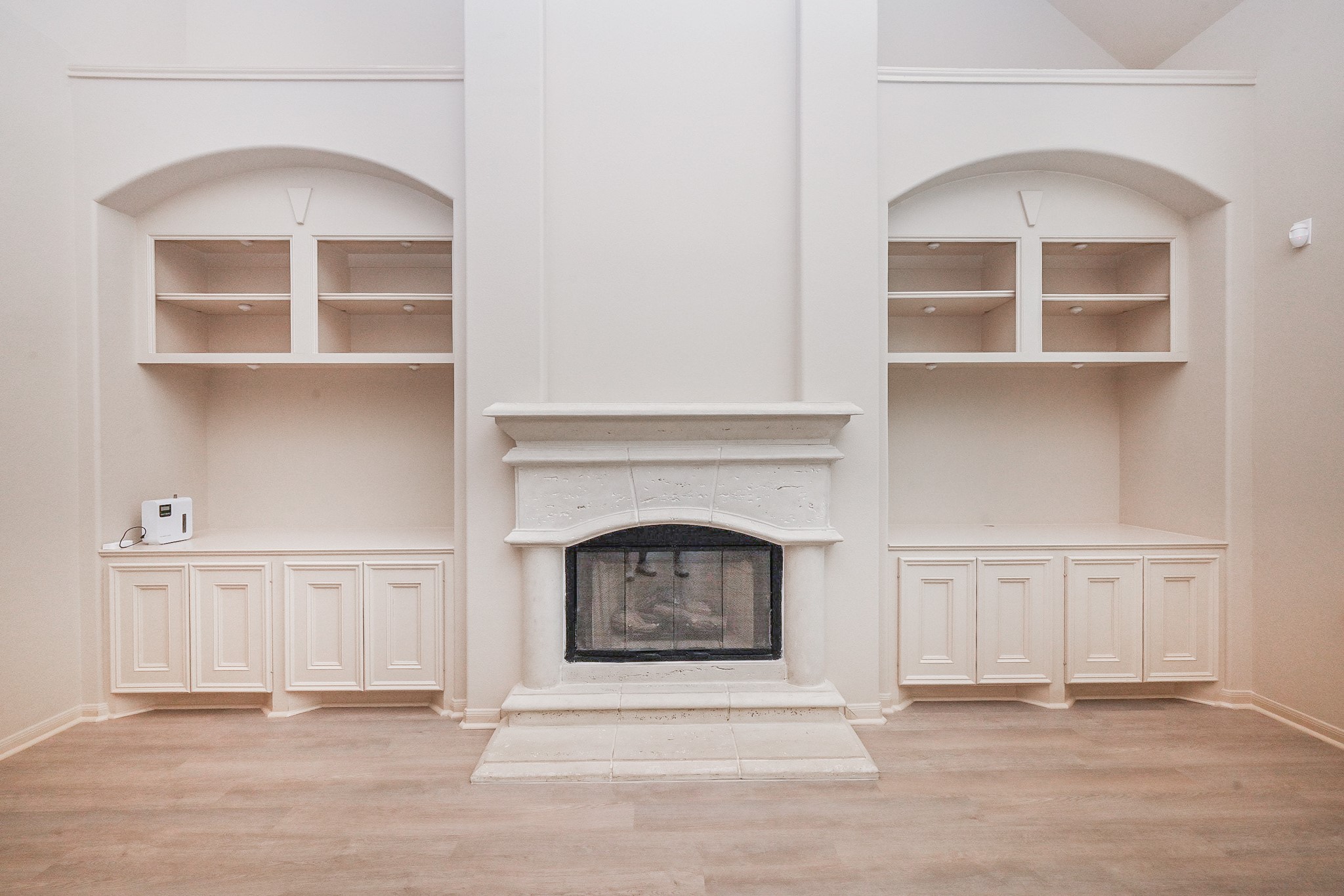 19 Sandwell Place Spring, TX 77389 - Photo 10 of 33 Living room with cozy fireplace and built-in shelves and cabinets