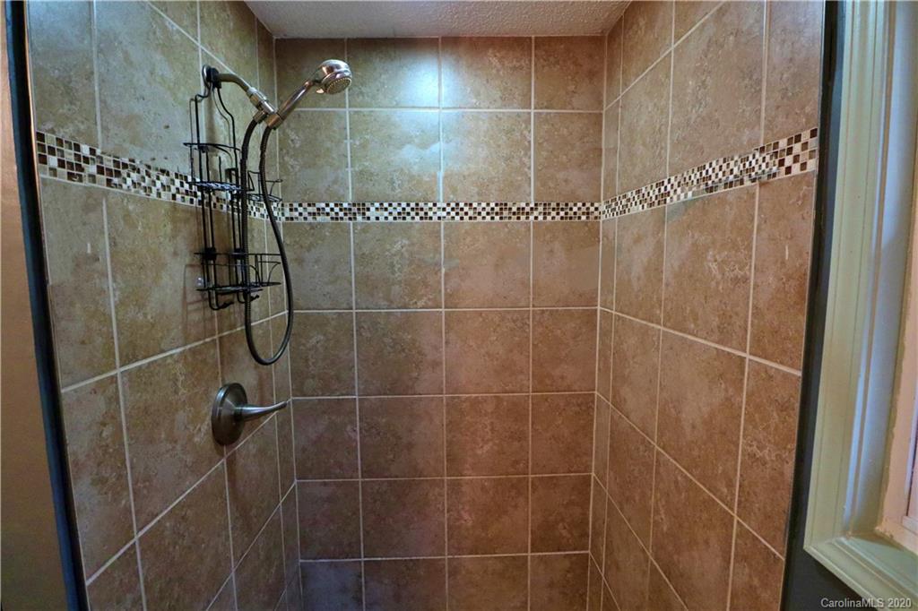128 Home Road Mill Spring, NC 28756 - Photo 14 of 36 a bathroom with a shower