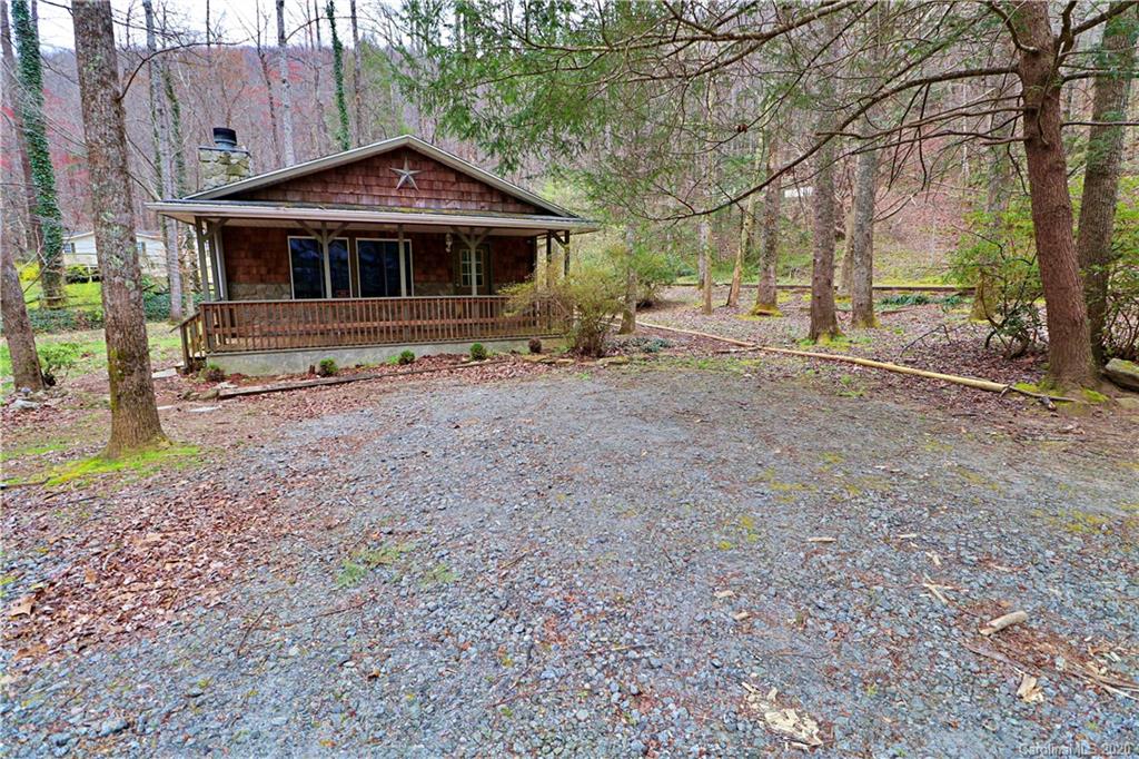 128 Home Road Mill Spring, NC 28756 - Photo 3 of 36 a front view of a house with garden