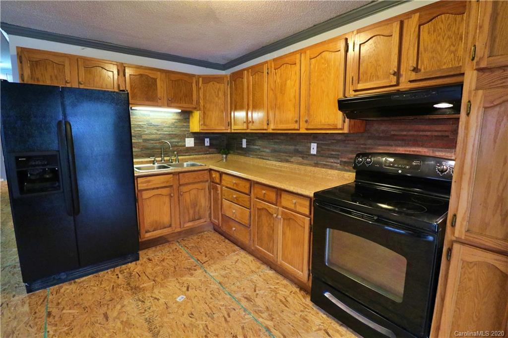 128 Home Road Mill Spring, NC 28756 - Photo 4 of 36 a kitchen with a stove a sink and a microwave