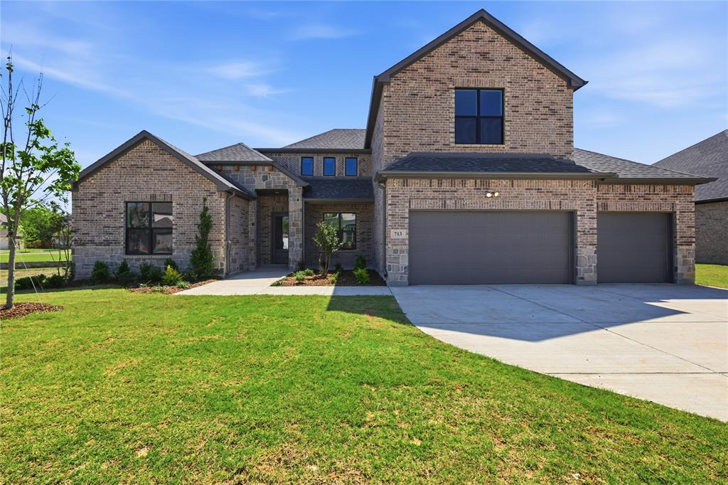 713 Anne Road Van Alstyne, TX 75495 - Photo 1 of 29 Brick and stone facade residence featuring a two-car garage and an additional single-car garage