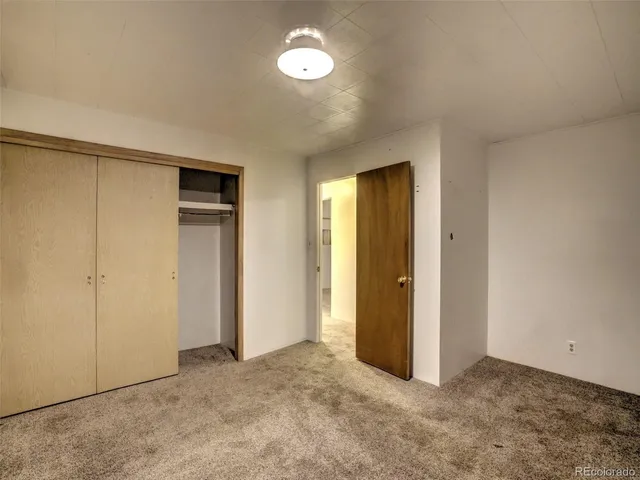 an empty room with closet area