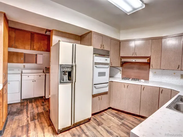a kitchen with stainless steel appliances a refrigerator and a stove top oven
