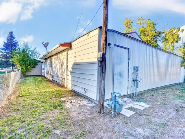 a view of empty room with wooden floor and door