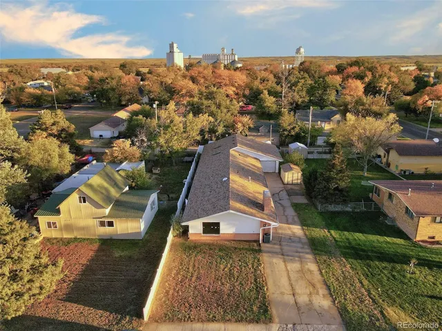 an aerial view of a house with a yard basket ball court and outdoor seating