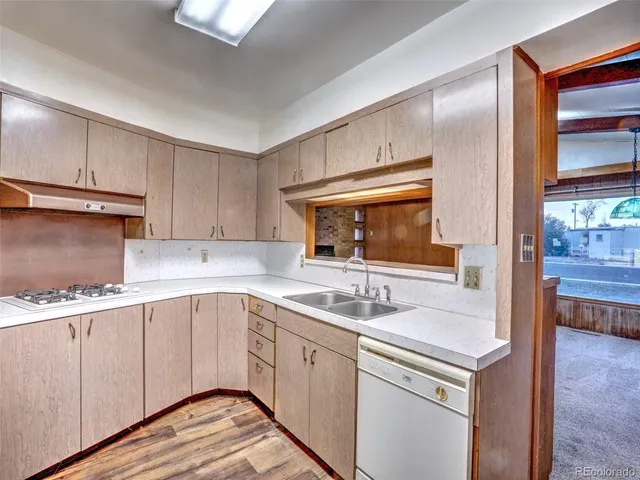 a kitchen with a sink stove and cabinets