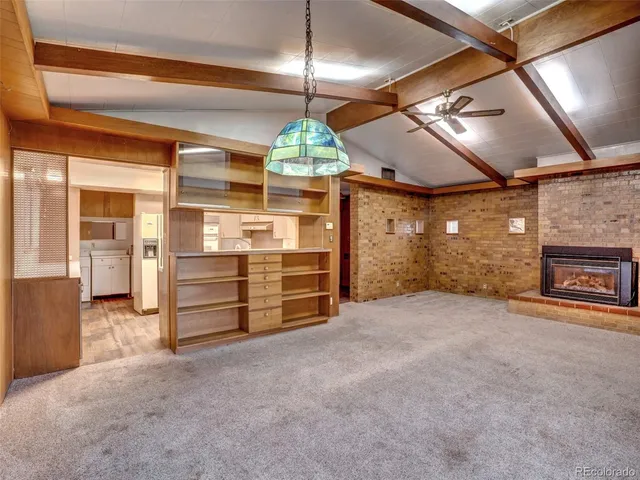 a view of empty room with wooden floor and fireplace