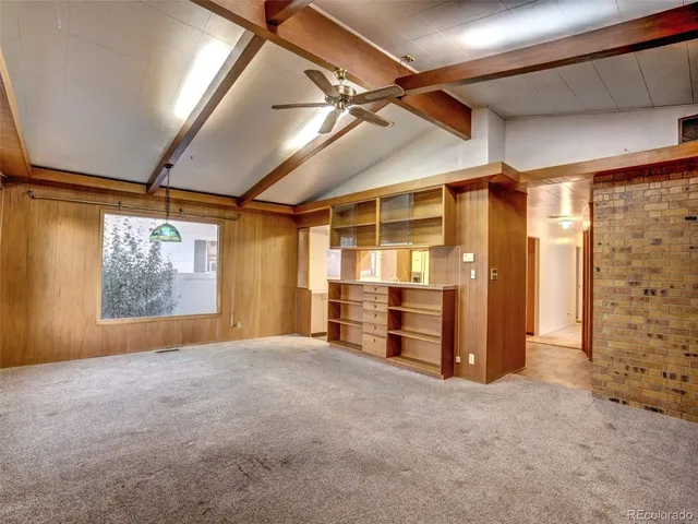 a view of empty room with wooden walls