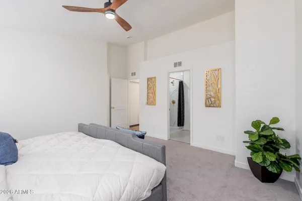 a bedroom with a bed potted plant and a window