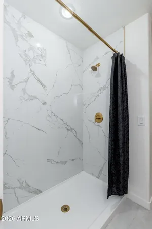 a bathroom with a tub and a shower