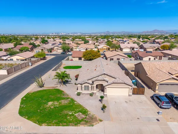 an aerial view of a house with a yard