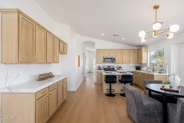 a kitchen with a sink stove and cabinets