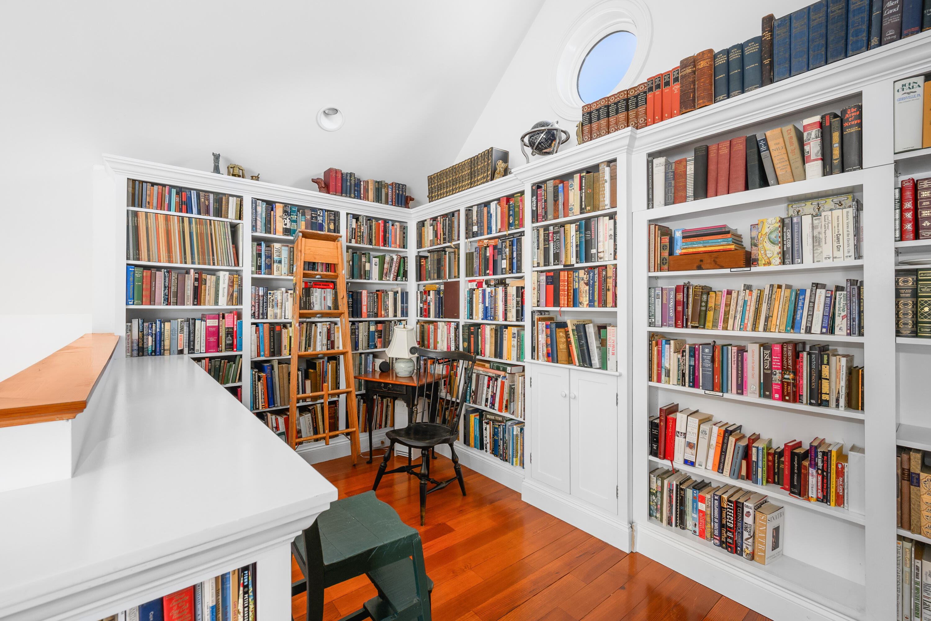 25 Pleasant View Drive Orleans, MA 02653 - Photo 45 of 56 a living room with lots of books and a book shelf
