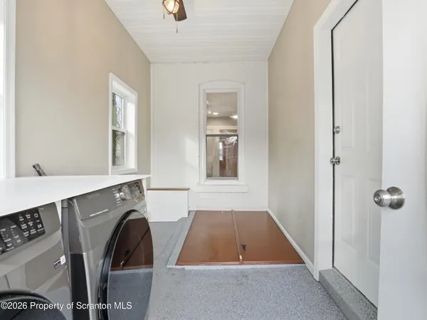 a room with washing machine and window