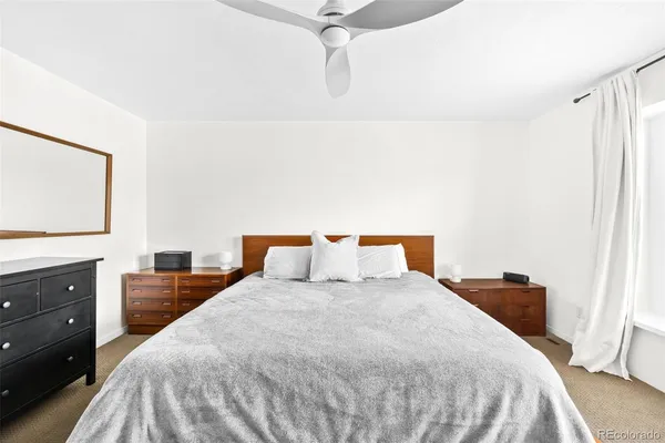 a bedroom with a large bed and a dresser