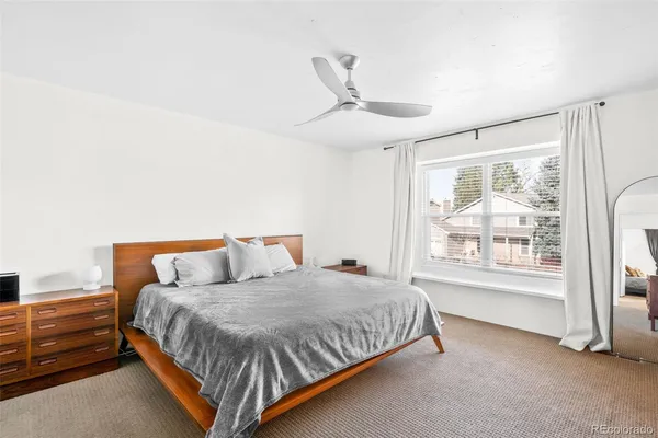 a bedroom with a large bed and a window