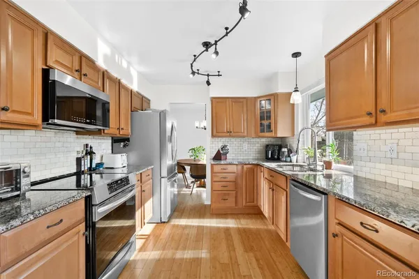 a kitchen with stainless steel appliances a stove sink microwave and cabinets
