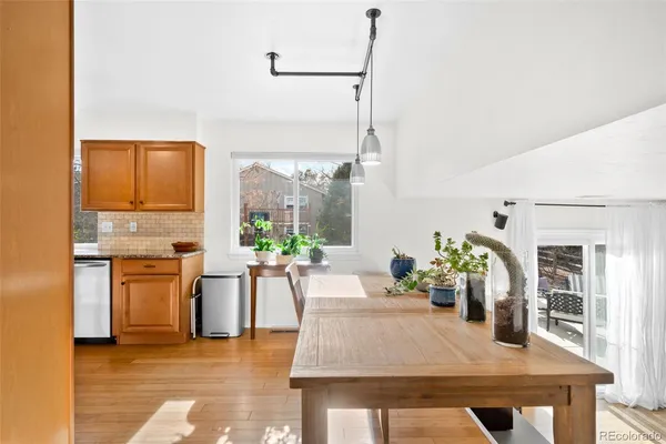 a view of a kitchen with kitchen island a counter top space a sink appliances and cabinets