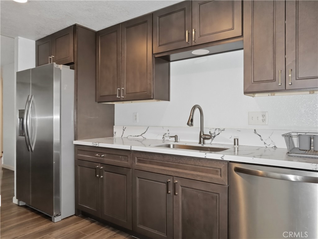 4409 Challen Avenue Riverside, CA 92503 - Photo 9 of 31 a kitchen with stainless steel appliances granite countertop a sink a refrigerator and cabinets