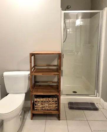 a bathroom with a toilet and a shower
