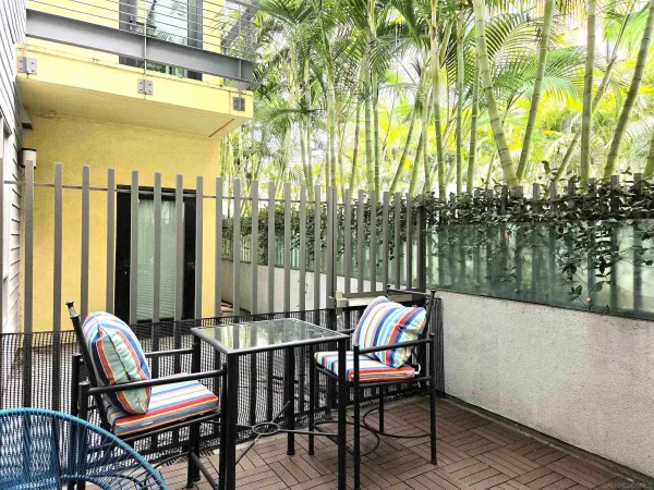 a view of a chairs and table in the balcony