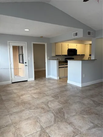 a view of a kitchen with a sink and microwave