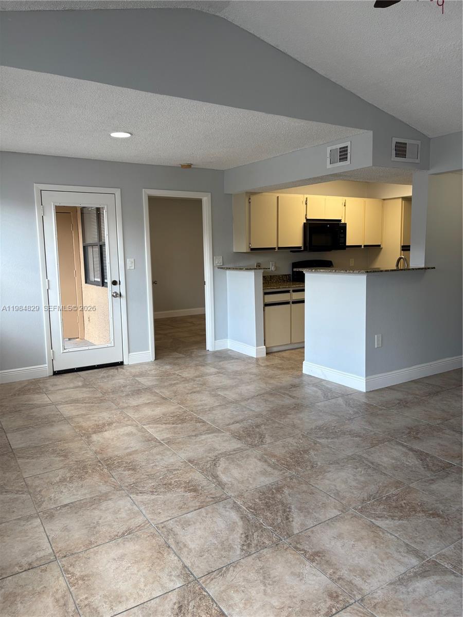 10501 Southwest 155th Court, Unit 1124 Miami, FL 33196 - Photo 4 of 15 a view of a kitchen with a sink and microwave