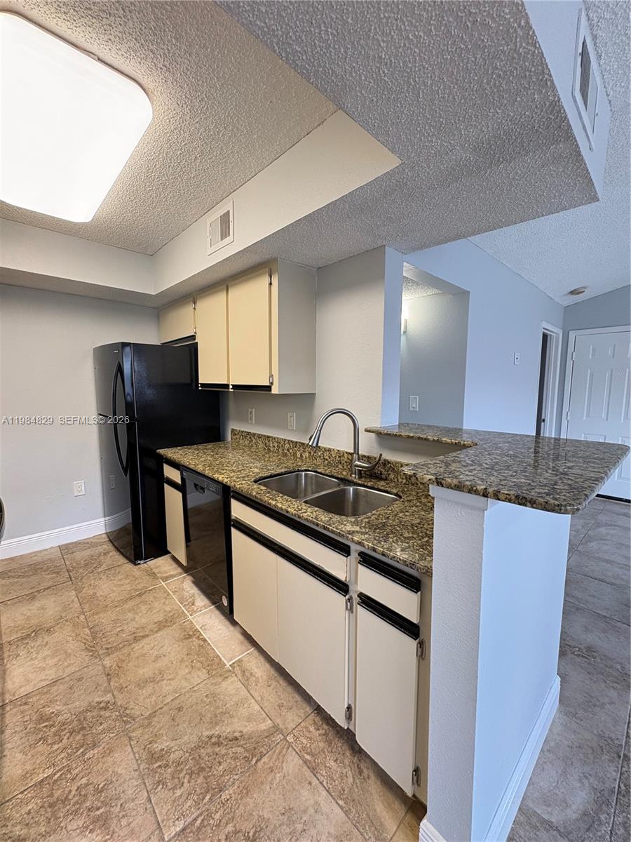 10501 Southwest 155th Court, Unit 1124 Miami, FL 33196 - Photo 5 of 15 a kitchen with stainless steel appliances granite countertop a sink and a refrigerator