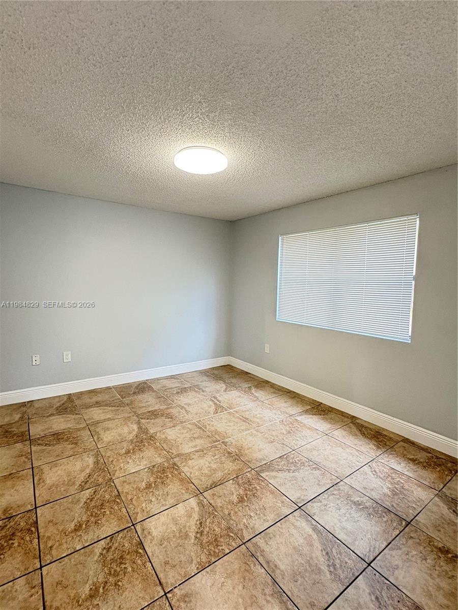 10501 Southwest 155th Court, Unit 1124 Miami, FL 33196 - Photo 7 of 15 an empty room with windows