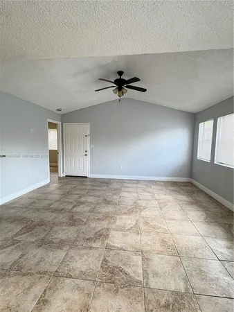 a view of an empty room and window fan