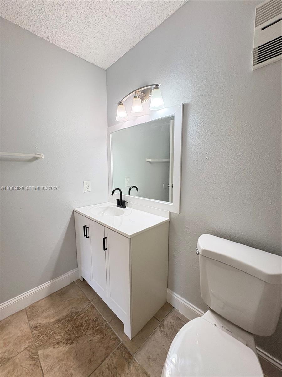 10501 Southwest 155th Court, Unit 1124 Miami, FL 33196 - Photo 9 of 15 a bathroom with a toilet sink and mirror