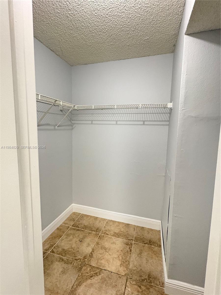 10501 Southwest 155th Court, Unit 1124 Miami, FL 33196 - Photo 10 of 15 a view of a room with racks on the wall