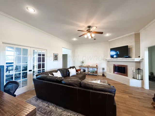 a living room with furniture a fireplace and a flat screen tv