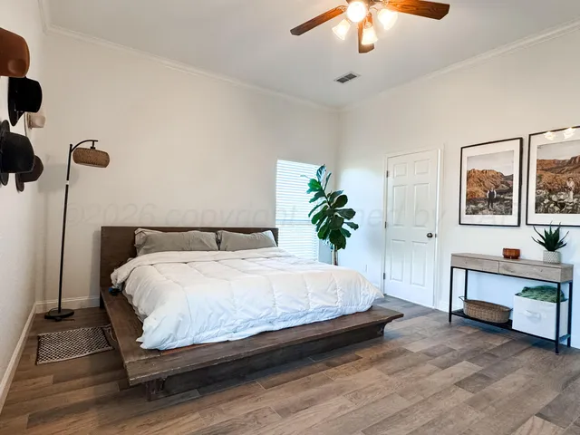 a large bed sitting in a room next to a chandelier