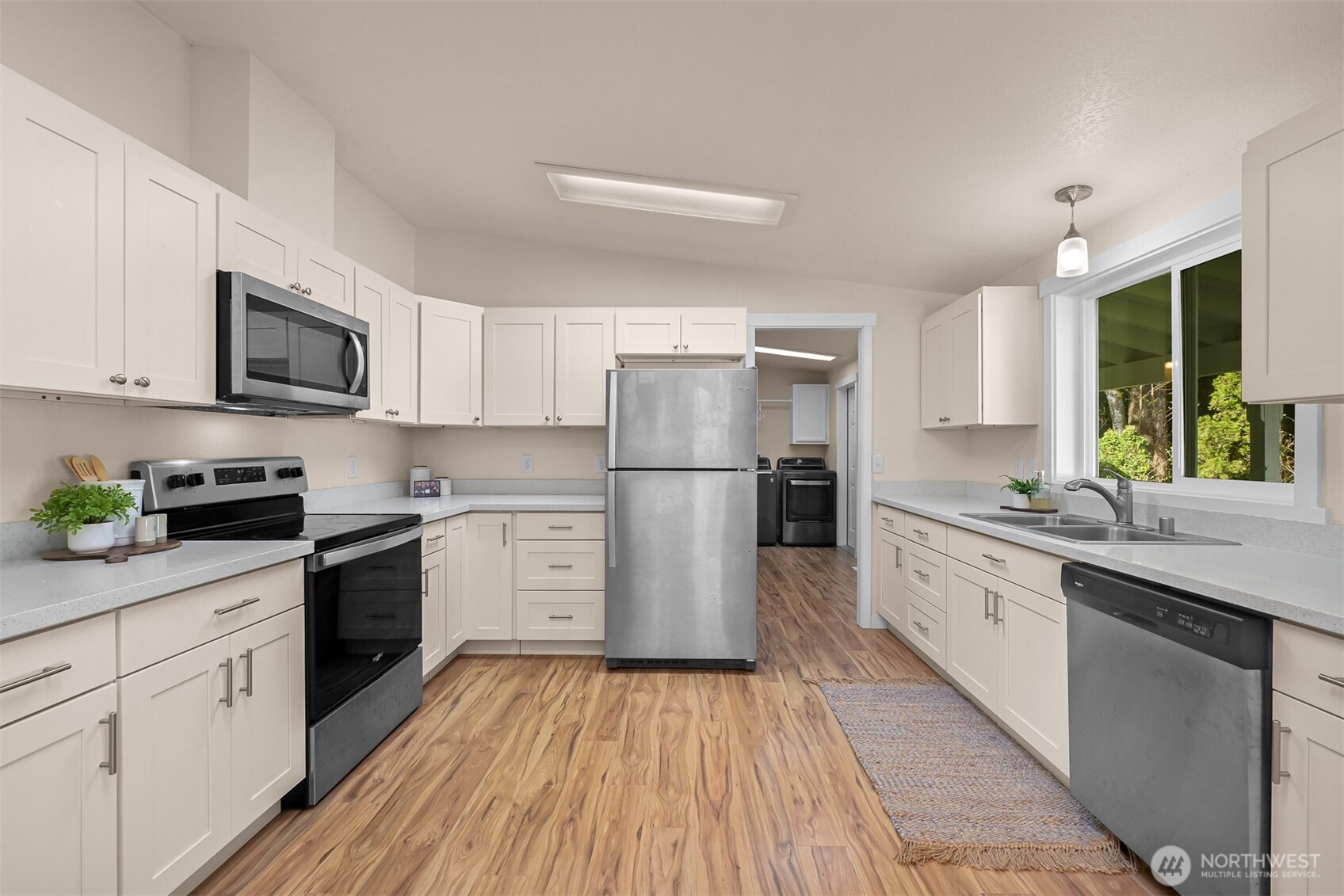 6159 Cedar Lane Maple Falls, WA 98266 - Photo 9 of 31 a kitchen with a white cabinets and wooden floor