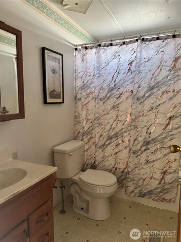 a white toilet sitting next to a bathroom sink